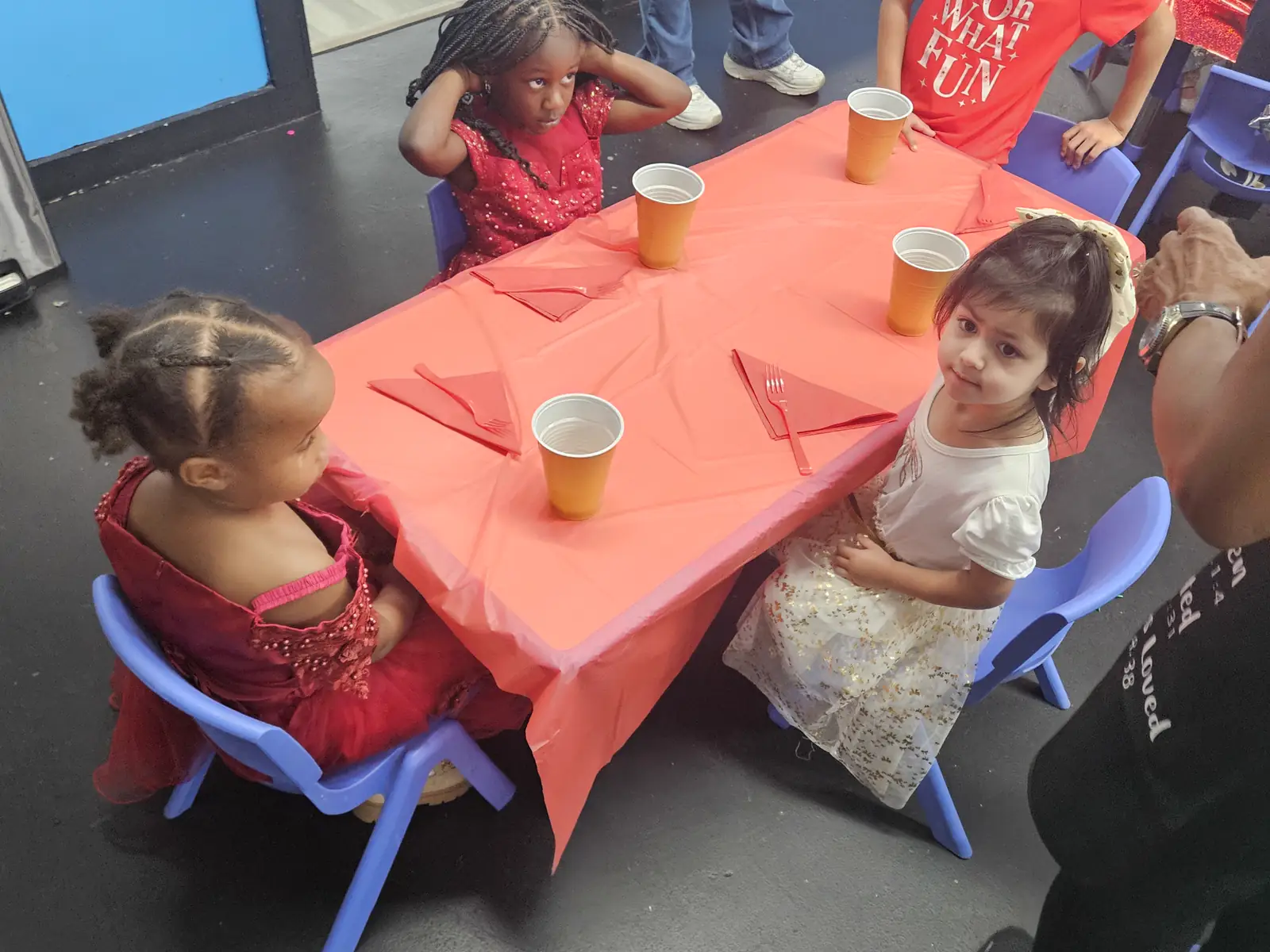 Children dressed up seated at holiday party table