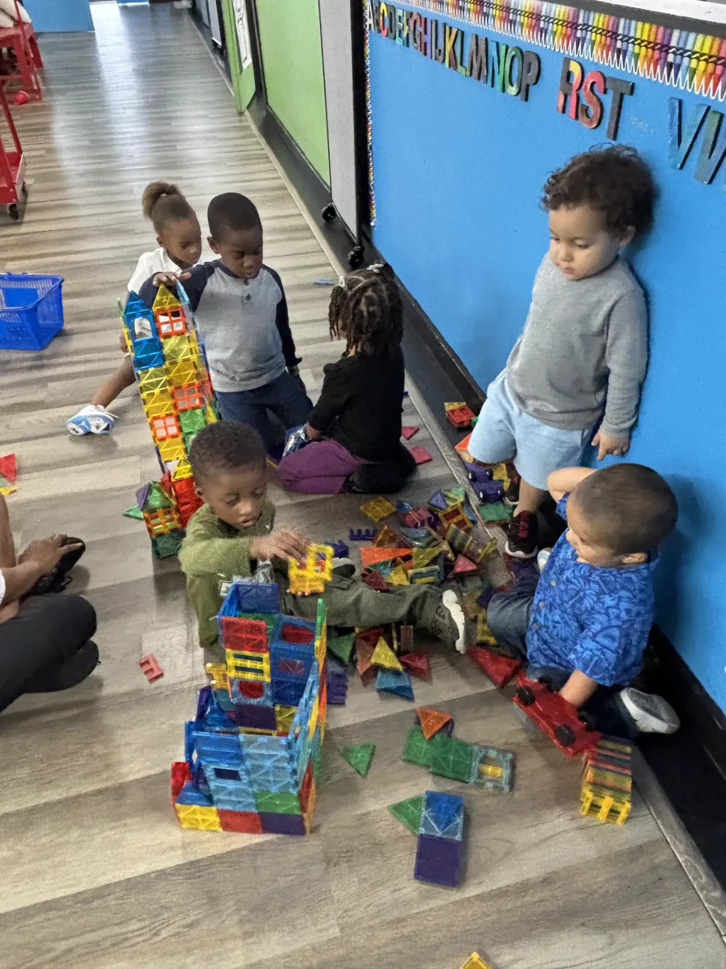 Children building magnetic tiles together in class